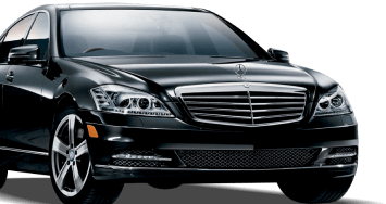 A sleek black Mercedes S-Class sedan parked elegantly, showcasing its luxurious design and sophisticated features.