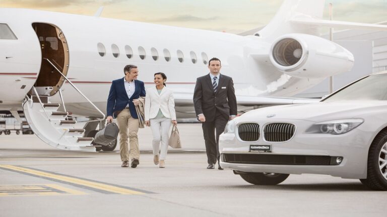 A group of individuals walking alongside a private jet on a tarmac, showcasing luxury travel and camaraderie.