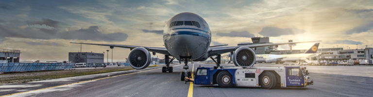 An airplane parked on the tarmac at an airport, ready for boarding or maintenance.