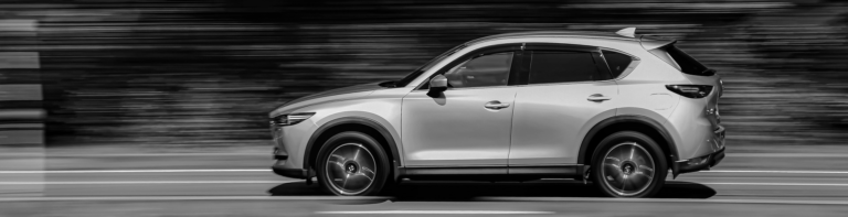 Mazda CX-5 captured in motion, showcasing its sleek design and dynamic performance on the road.