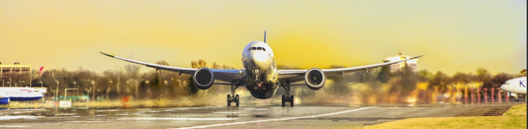 A large jet airplane ascends into the sky as it takes off from the runway, showcasing its powerful engines and wings.