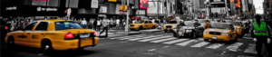 A bustling city street filled with taxis and cars navigating through traffic.