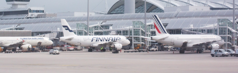 Airplanes parked on the tarmac at an airport, ready for departure or awaiting maintenance.