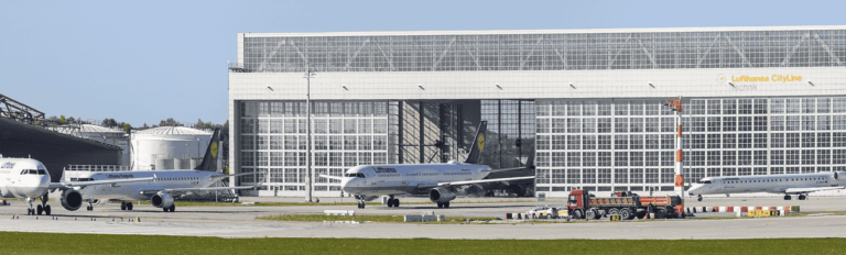 A cluster of airplanes stationed on a runway, ready for departure or awaiting maintenance