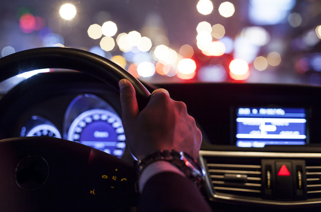 hands on wheel and city nightlife