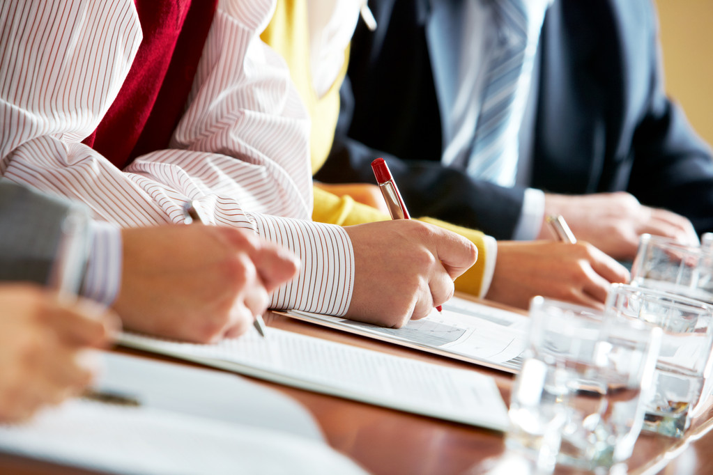 Close-up of human hands over business documents during conference