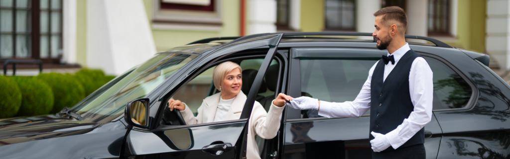Valet's Hand Opening Grey Car Door On Street