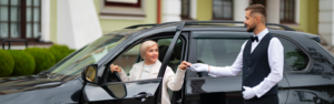 Valet's Hand Opening Grey Car Door On Street