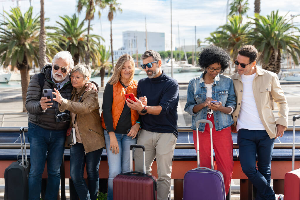 A group of tourists using phones