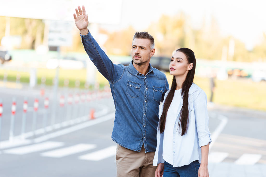 Couple adult people calling in taxi street