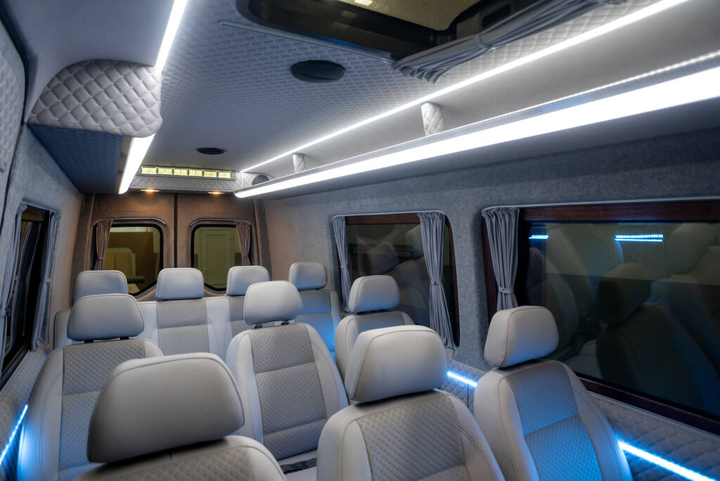Comfortable passenger bus interior featuring upholstered seats