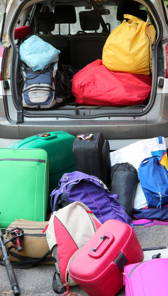 lots of luggage ready to be loaded on a car for the holidays