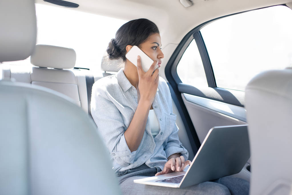 Woman in taxi using a phone