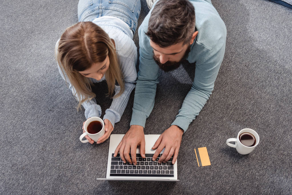 Couple working on a laptop while