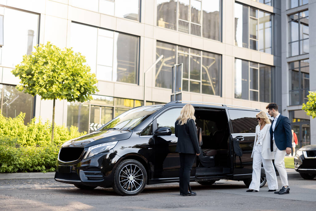 Minivan with female chauffeur and passengers