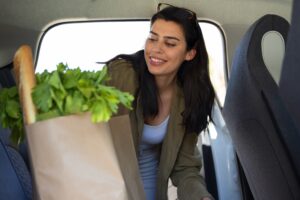 front-view-smiley-woman-with-groceries