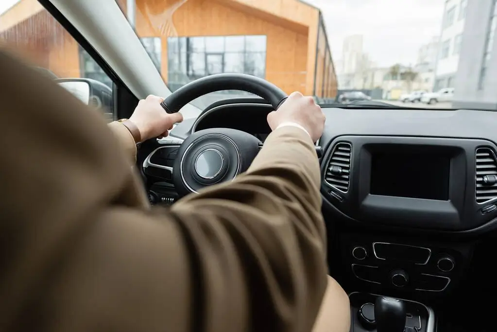 Close-up shot of man driving a car