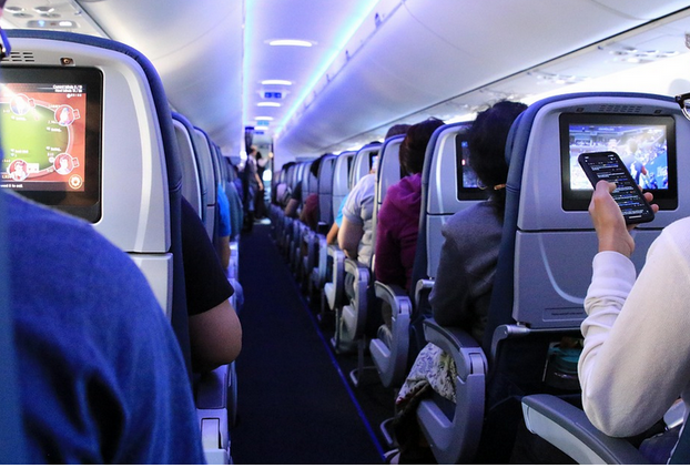 Inside plane passengers sitting on the seats