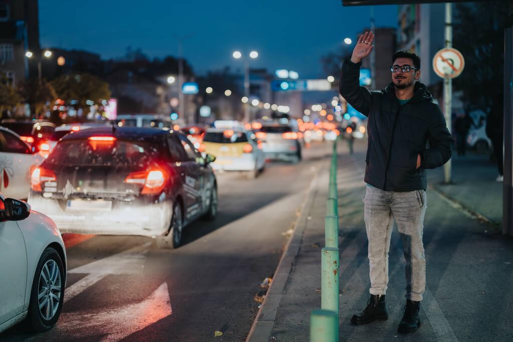 Man signaling the taxi in heavy traffic city